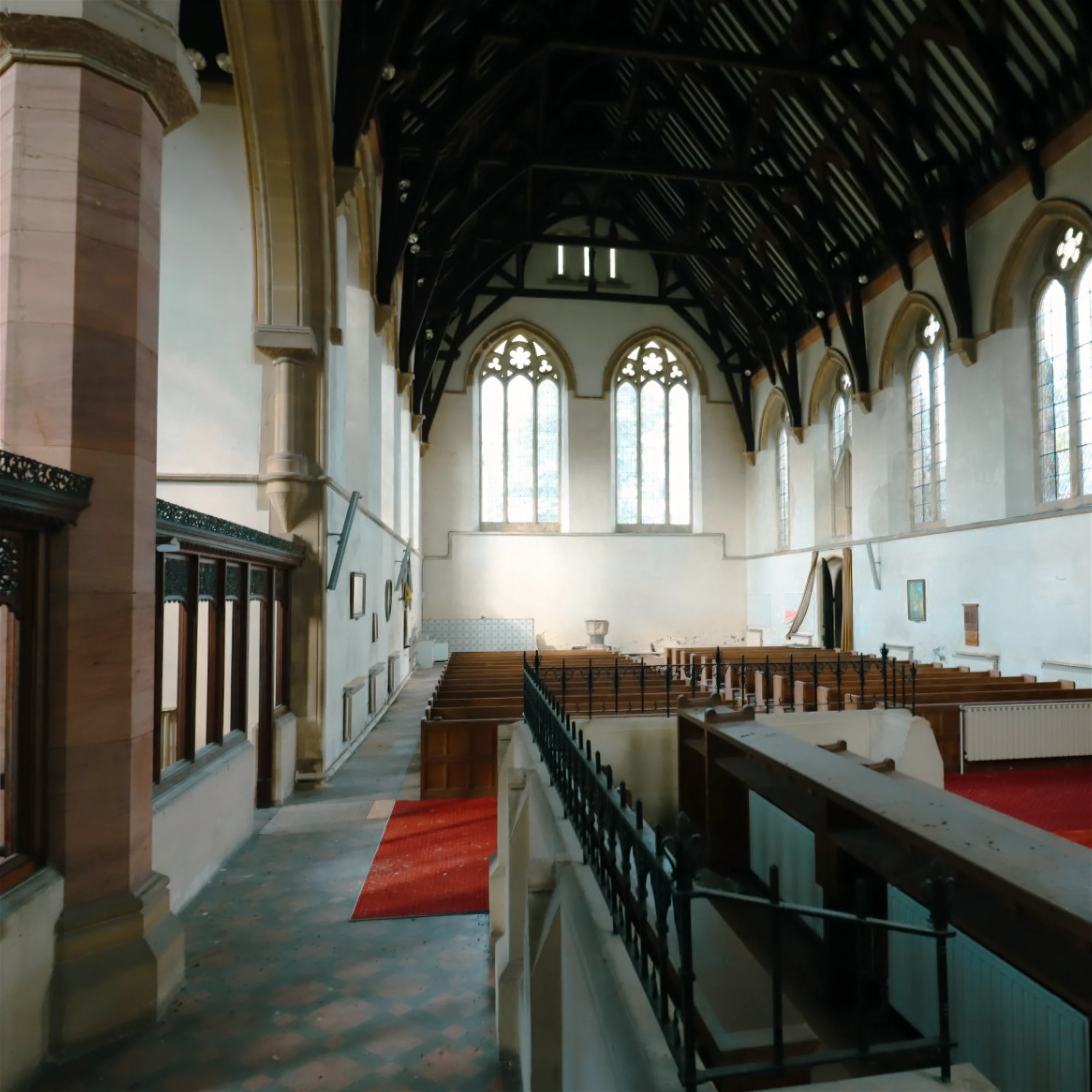 Interior of St John’s Church Coleford showing the nave, timber roof structure, Gothic windows and original pews